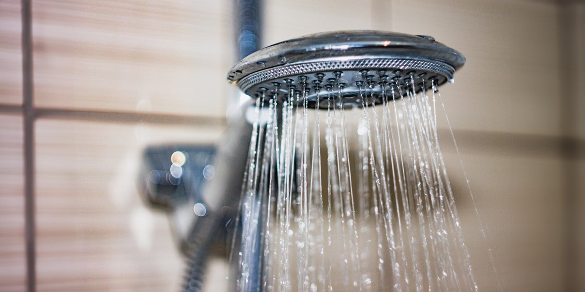 Shower head with drops of water falling down.